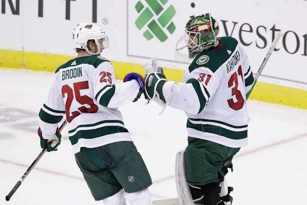 Wild defenseman Jonas Brodin celebrated with goaltender Kaapo Kahkonen after the goalie posted a 3-2 victory over the New Jersey Devils in his NHL deb