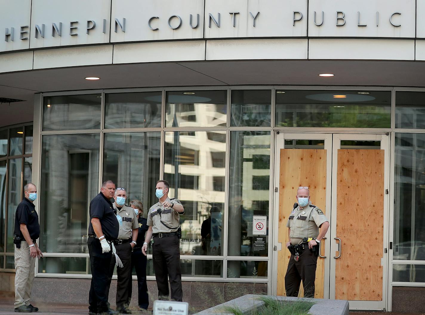 Law enforcement officers outside the Hennepin County jail on Tuesday morning, where windows were broken during a demonstration.