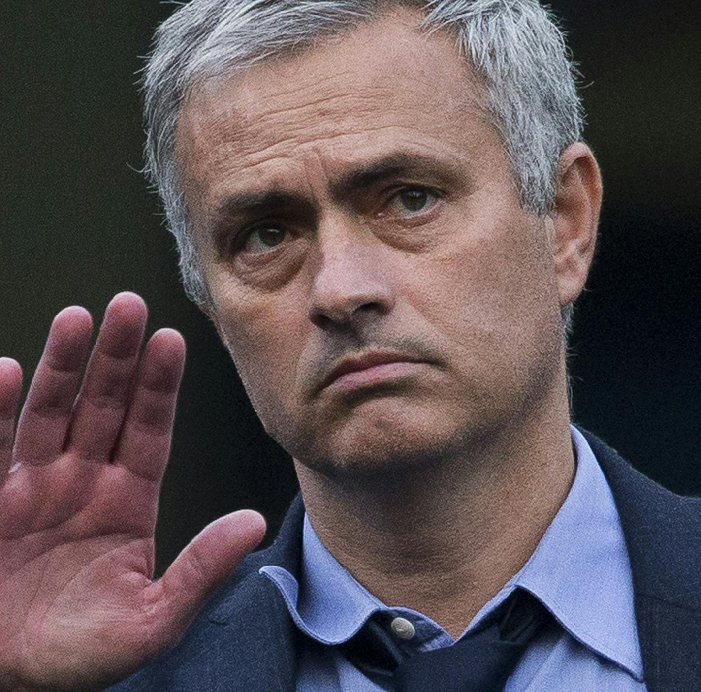 FILE- In this Saturday, Oct. 31, 2015 file photo, Chelsea's head coach Jose Mourinho waves at fans as he talks with his coaching staff after coming back out onto the pitch after the English Premier League soccer match between Chelsea and Liverpool at Stamford Bridge stadium in London. Liverpool won the match 3-1. Mourinho has left Chelsea with the club languishing one point above the relegation zone just seven months after winning the Premier League title, it was reported on Thursday, Dec. 17, 2