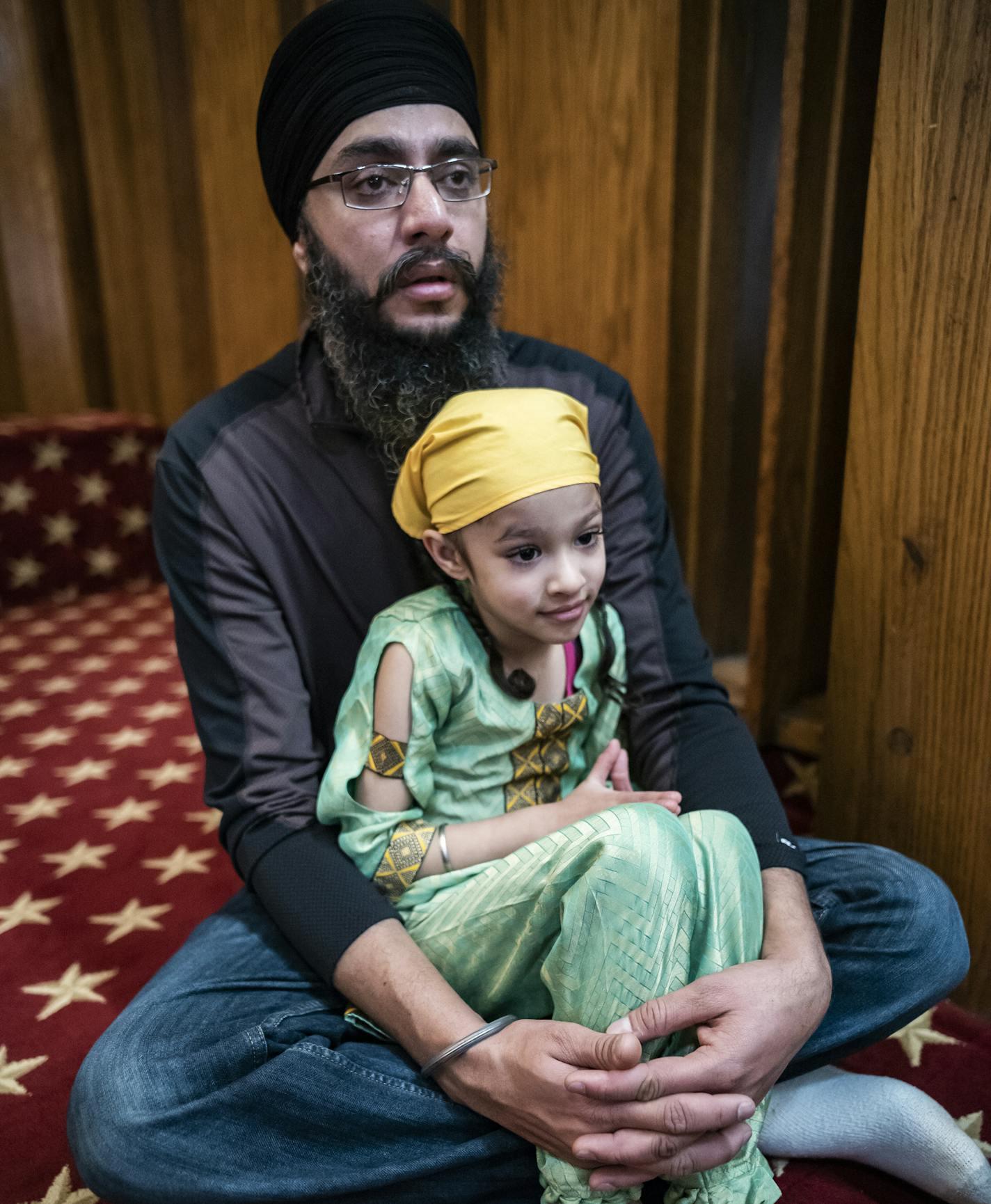 Gurdeep Singh and his daughter Keerat,4, sit together during the service. Singh's family sponsored the communal feast after service.] Sikhs across the nation have set aside this week to try to try to demystify the faith and counter growing prejudice. That includes the Minnesota Sikh Society, which is hosting an open house at its Bloomington templeRICHARD TSONG-TAATARII &#xa5; richard.tsong-taatarii@startribune.com