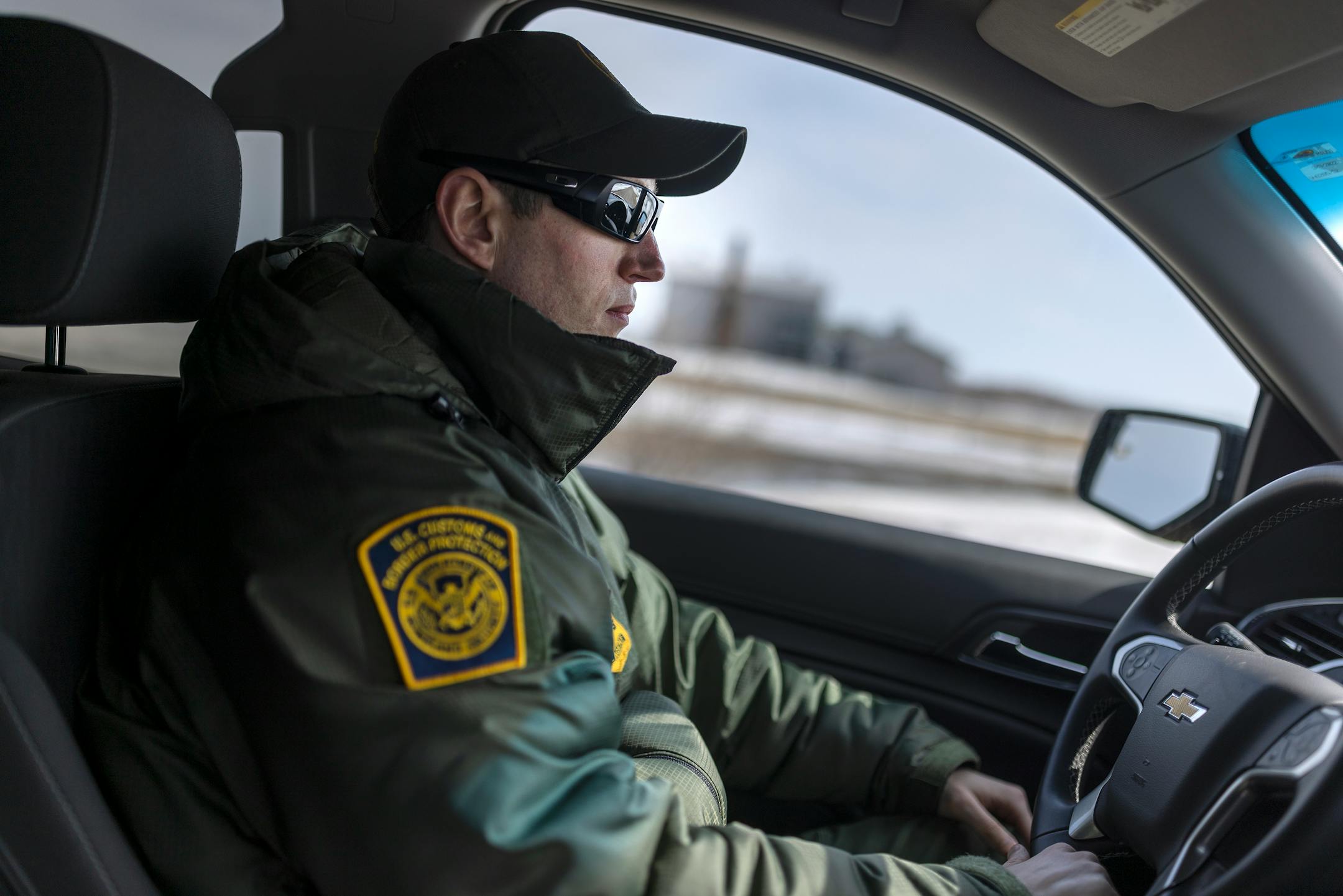 Customs and Border Patrol agent David Marcus drives past a building where two citizens from India and their human trafficker were found in the middle of a blizzard near Pembina, Minn., on Monday, March 21, 2022.
