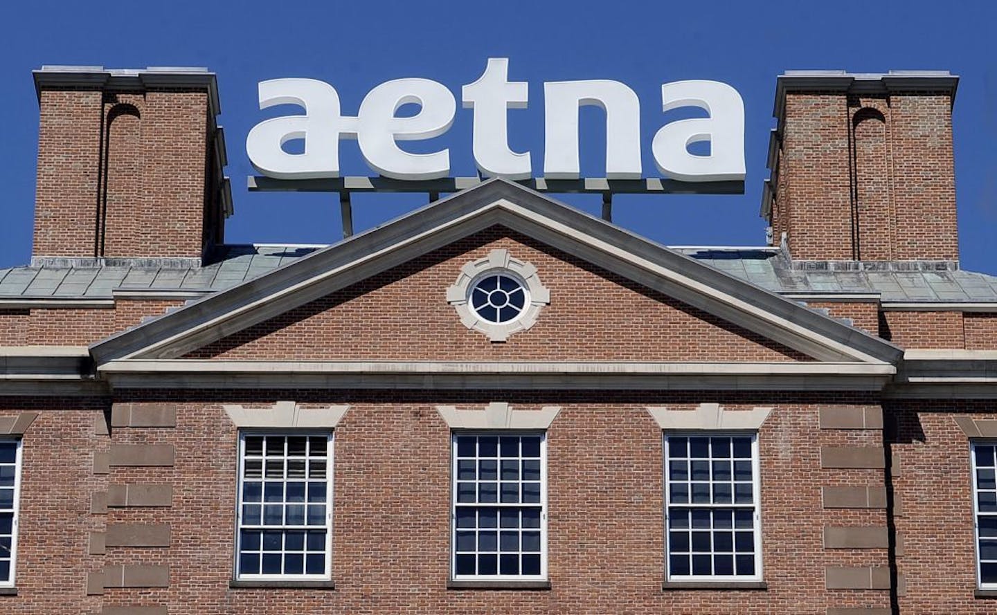 FILE - In this Tuesday, Aug. 19, 2014, file photo, a sign for Aetna Inc., sits atop a building at the company headquarters in in Hartford, Conn. Health insurer Aetna Inc. has made a deal to buy competitor Humana Inc. in a $37 billion deal the companies say would create the second-largest managed care company, it was announced Friday, July 3, 2014.