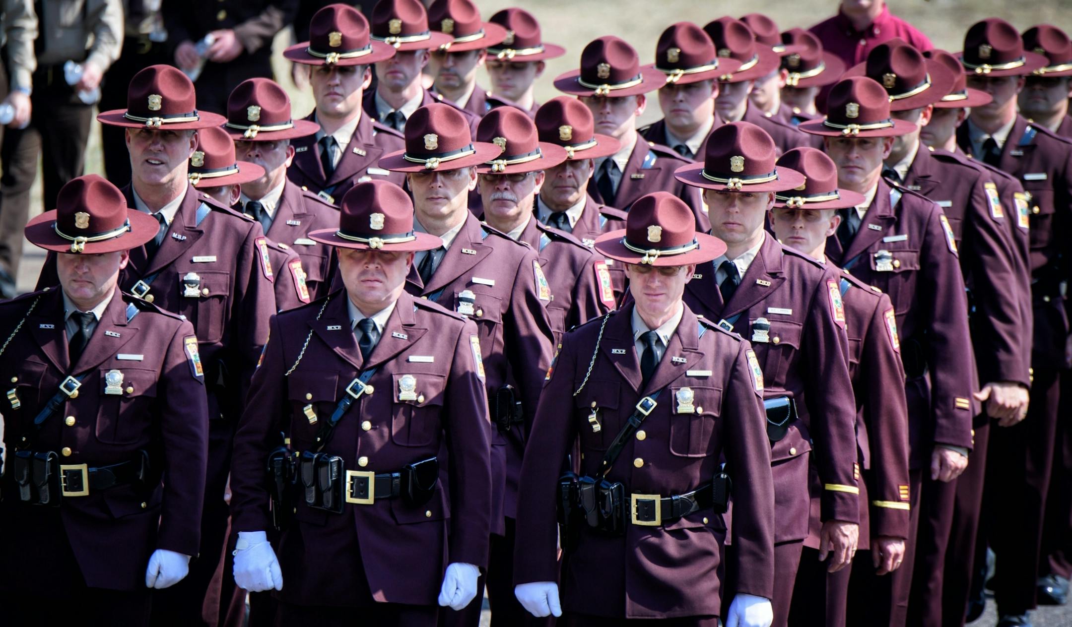 Minnesota State Troopers were among hundreds of law enforcement officers from Minnesota and across the country paid tribute to Officer William Mathews, here at his burial ceremony at Summit Park Cemetery.
