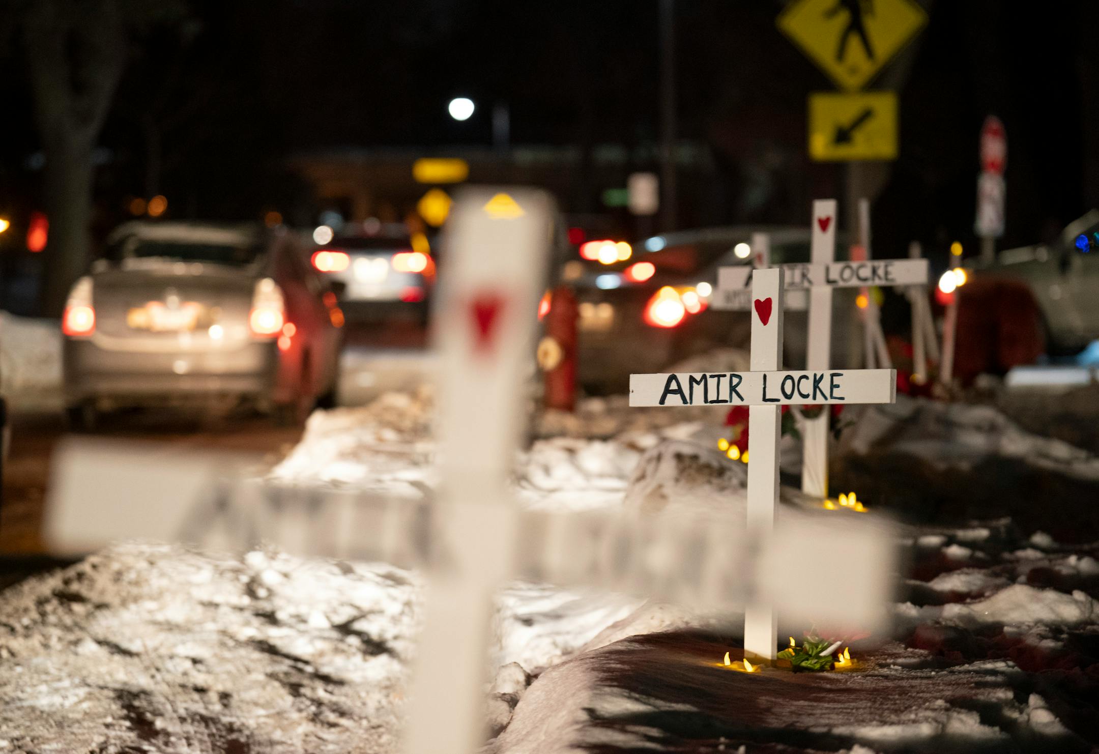 Following a demonstration, a caravan of cars paraded passed crosses planted in the boulevard outside homes in the Cedar-Isles-Dean on Sunday night, February 6, 2022 in Minneapolis.