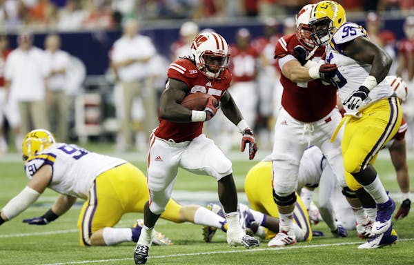 Wisconsin's Melvin Gordon runs for a 14-yard touchdown during the first half of an NCAA college football game against LSU Saturday, Aug. 30, 2014, in 