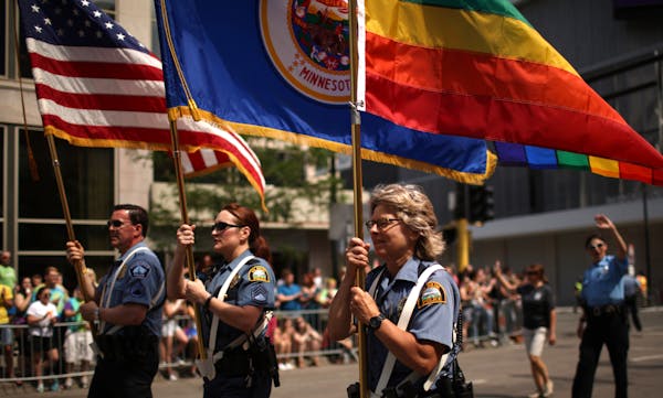 Officers from Minneapolis and St. Paul police departments lead the Twin Cities Pride parade down Hennepin Avenue in 2015.