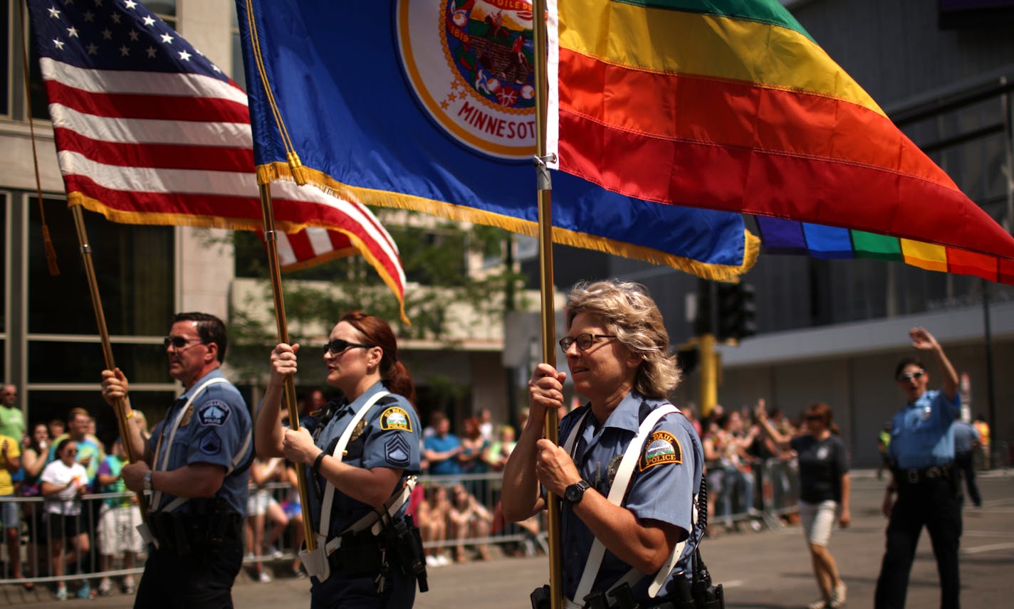 Officers from Minneapolis and St. Paul police departments lead the Twin Cities Pride parade down Hennepin Avenue in 2015.