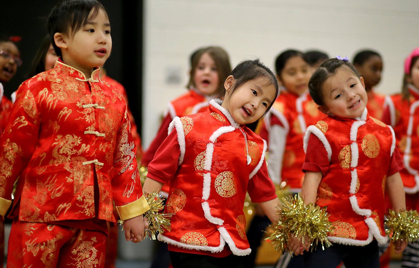 Jie Ming Mandarin Immersion Academy students, who attend classes in a wing of Hamline Elementary School, performed songs and dances for Hamline Elementary students as part of Chinese New Year festivities. Here, Jie Ming first graders Alphonse Lor, Madison Her, and Skura Callahan, sing and dance Tuesday, Feb. 17, 2015, in St. Paul, MN.](DAVID JOLES/STARTRIBUNE)djoles@startribune.com Four years ago, the St. Paul School District launched a Chinese immersion program, and started small -- with just k