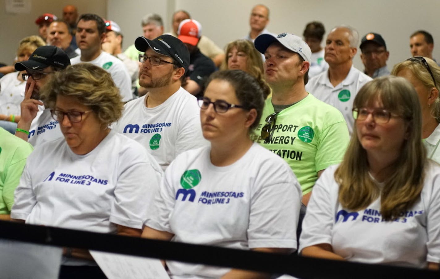 Some supporters of the Line 3 pipeline sat in the back of the commissioners' meeting on Thursday in St. Paul.