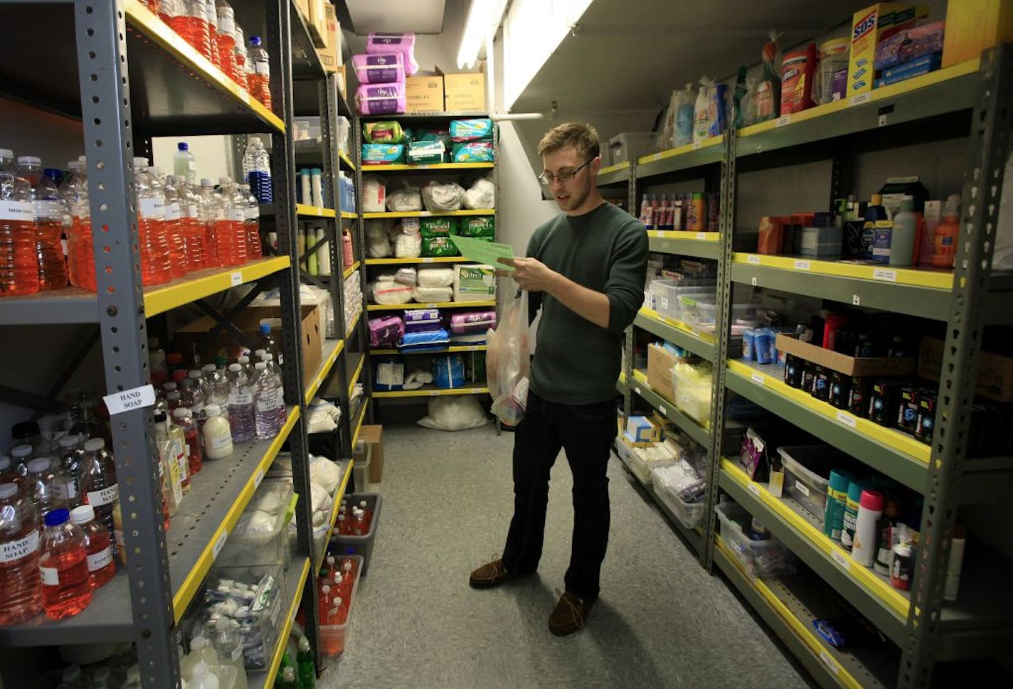 Dylan Christiansen of the ICA Food Shelf bag up groceries that they will deliver to the people in need. Minnetonka, MN on September 25, 2012.