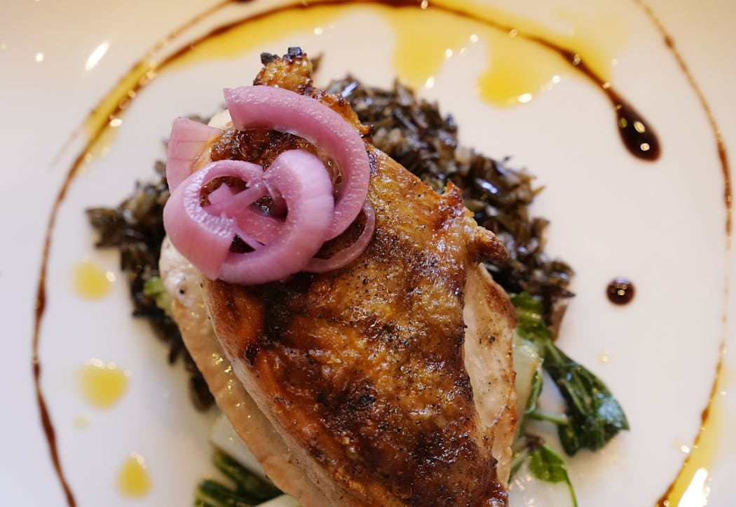 Grilled chicken breast with sesame wild rice, pickled onions, bok choy and a sesame glaze at La Ferme in Alexandria, Minn.