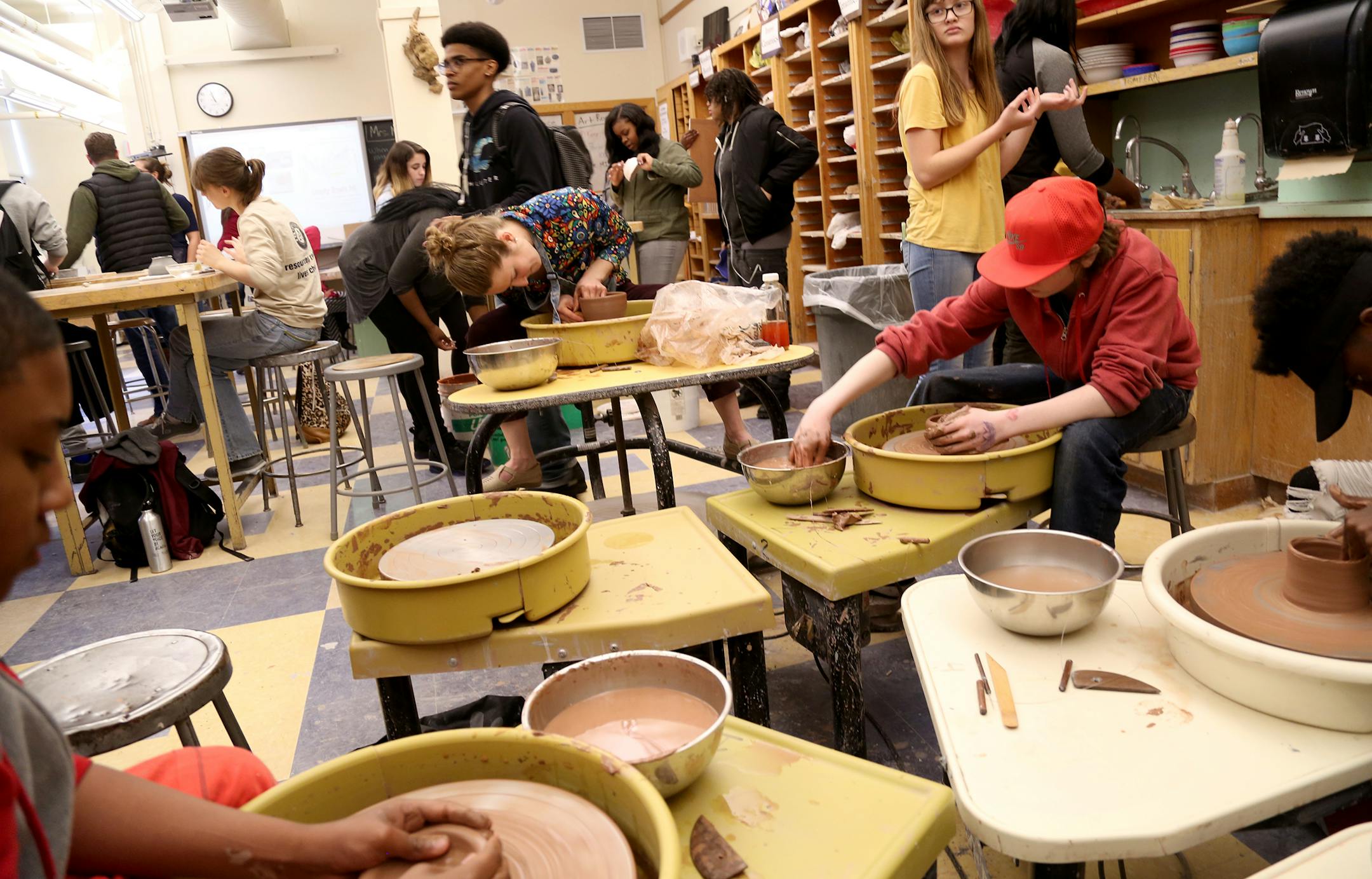 Art teacher Rachel Hoemke, rear center, works on throwing a bowl for the Empty Bowls fundraiser at Edison High School Thursday, April 13, 2017, in Minneapolis, MN.