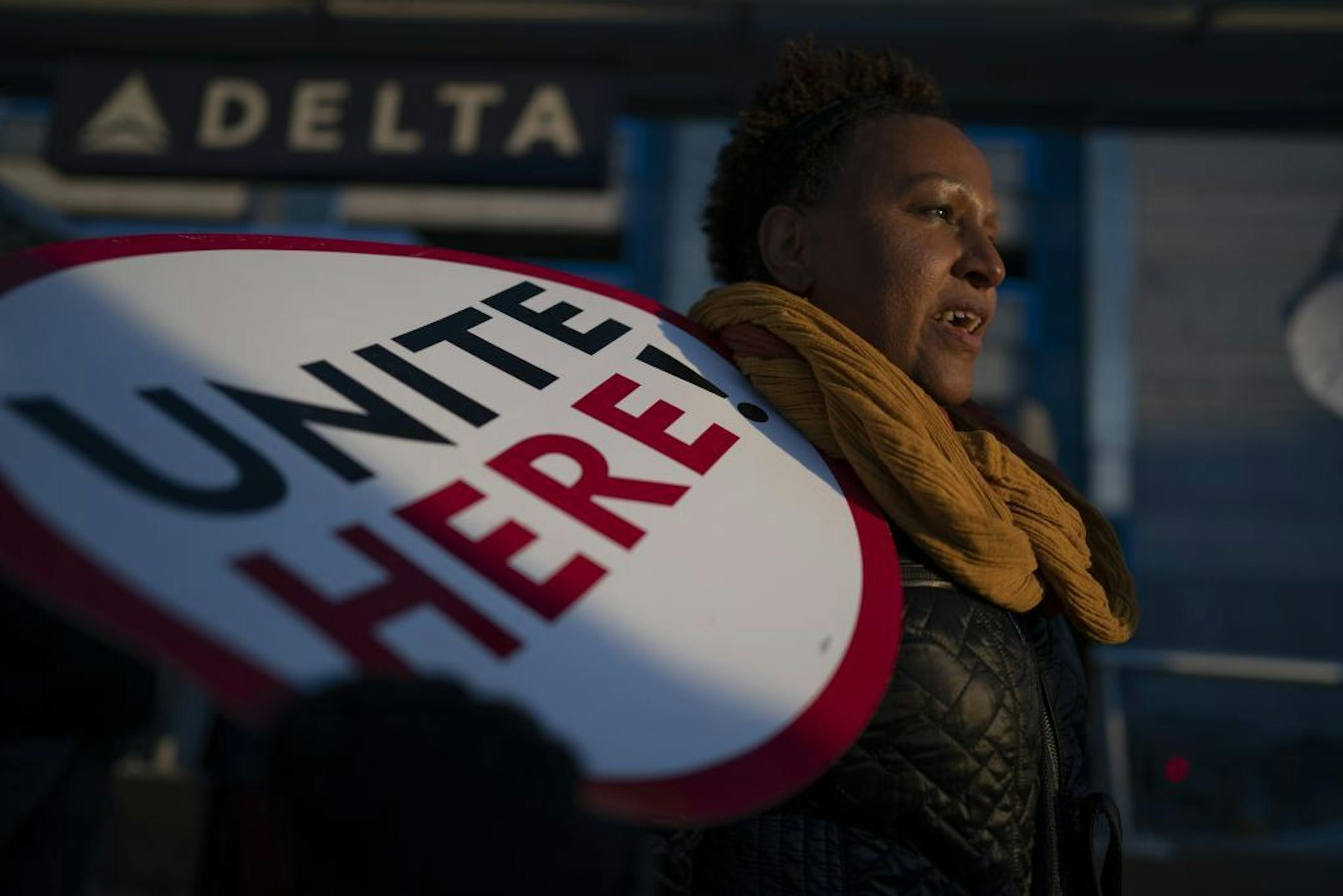 Feben Ghilagaber works as a server at a restaurant in the airport marched with other workers during a rally for a $15 minimum wage Thursday November 21, 2018 in Bloomington, MN.