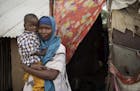 In this photo taken Monday, July 31, 2017, Somali refugee and mother of four Asho Manangara Ibrahim, 30, holds her one-year-old son Juuma Maday Jeylan