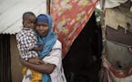 In this photo taken Monday, July 31, 2017, Somali refugee and mother of four Asho Manangara Ibrahim, 30, holds her one-year-old son Juuma Maday Jeylan