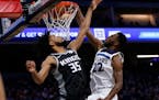 Wolves forward Andrew Wiggins duned over Kings forward Marvin Bagley III during the first quarter Thursday,
