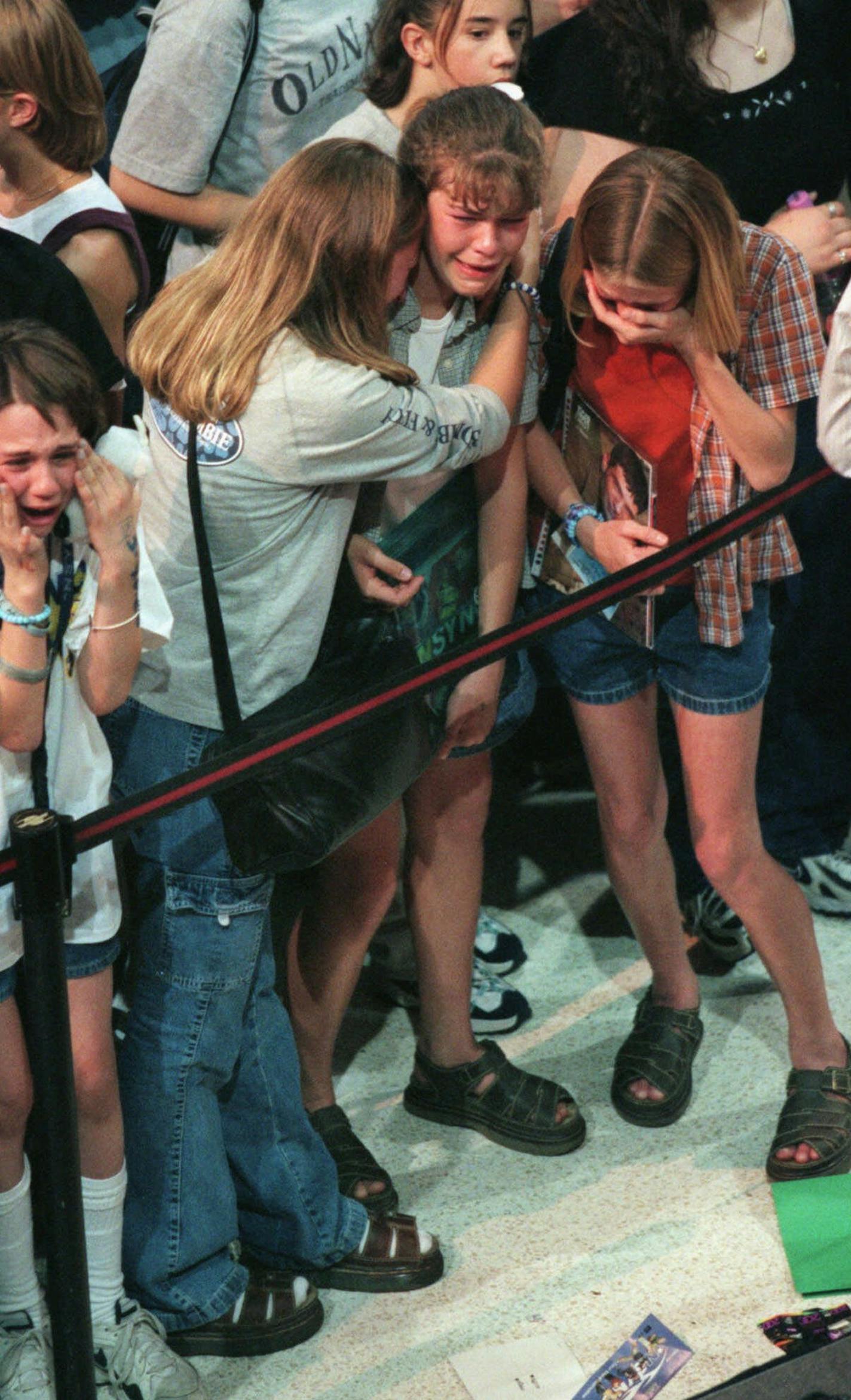 Woodbury teens hug each other and cry after their idols, the rock group N Sync, were whisked away from an autograph session at the Mall of America in Bloomington by security after someone in the crowd threw a water balloon from the upper level of the rotunda, Thursday, May, 6, 1999. The balloon landed on a table where the band members were signing autographs. Teens were overcome with frustration as many of them had been waiting since 5am. From left are, Courtney Thomas; Jillian Rubbert; Jennifer