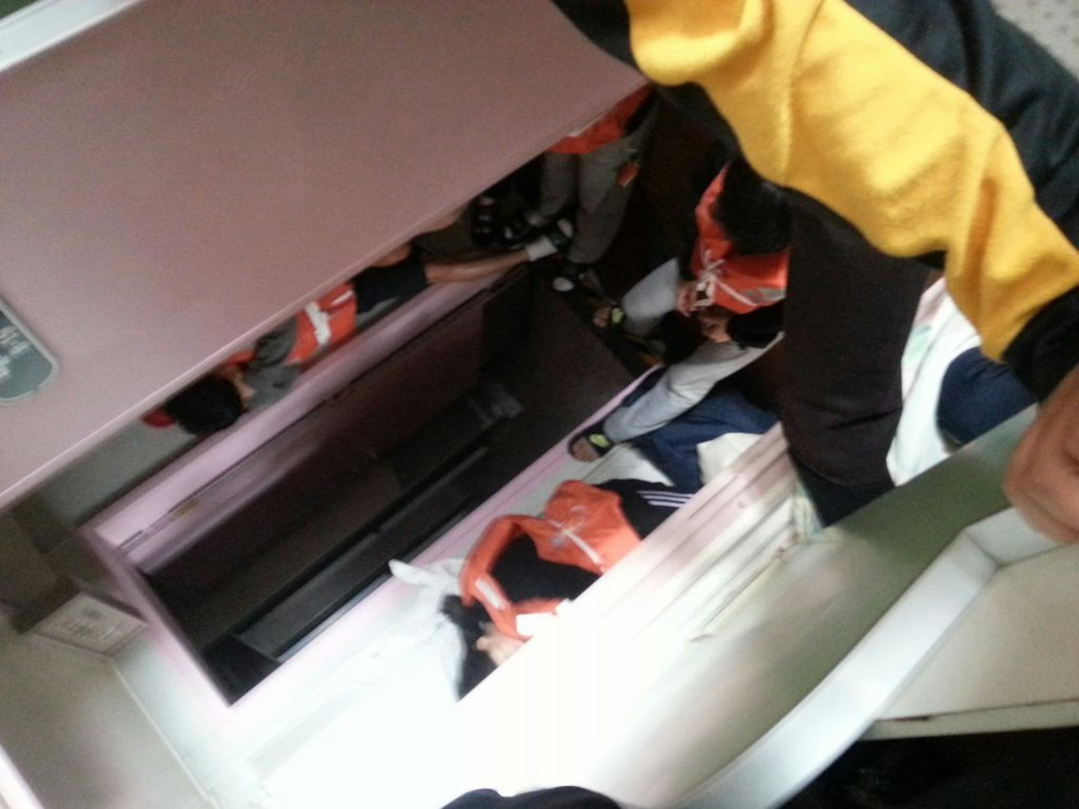 In this April 16, 2014 photo taken with a mobile phone by deceased South Korean high school student Park Su-hyeon and released by his father Park Jong-dae, students are shown inside the sinking ferry Sewol on waters near Jindo, South Korea. Soon after the ferry begins to tilt, nervous laughter can be heard from the high school students huddled below deck.