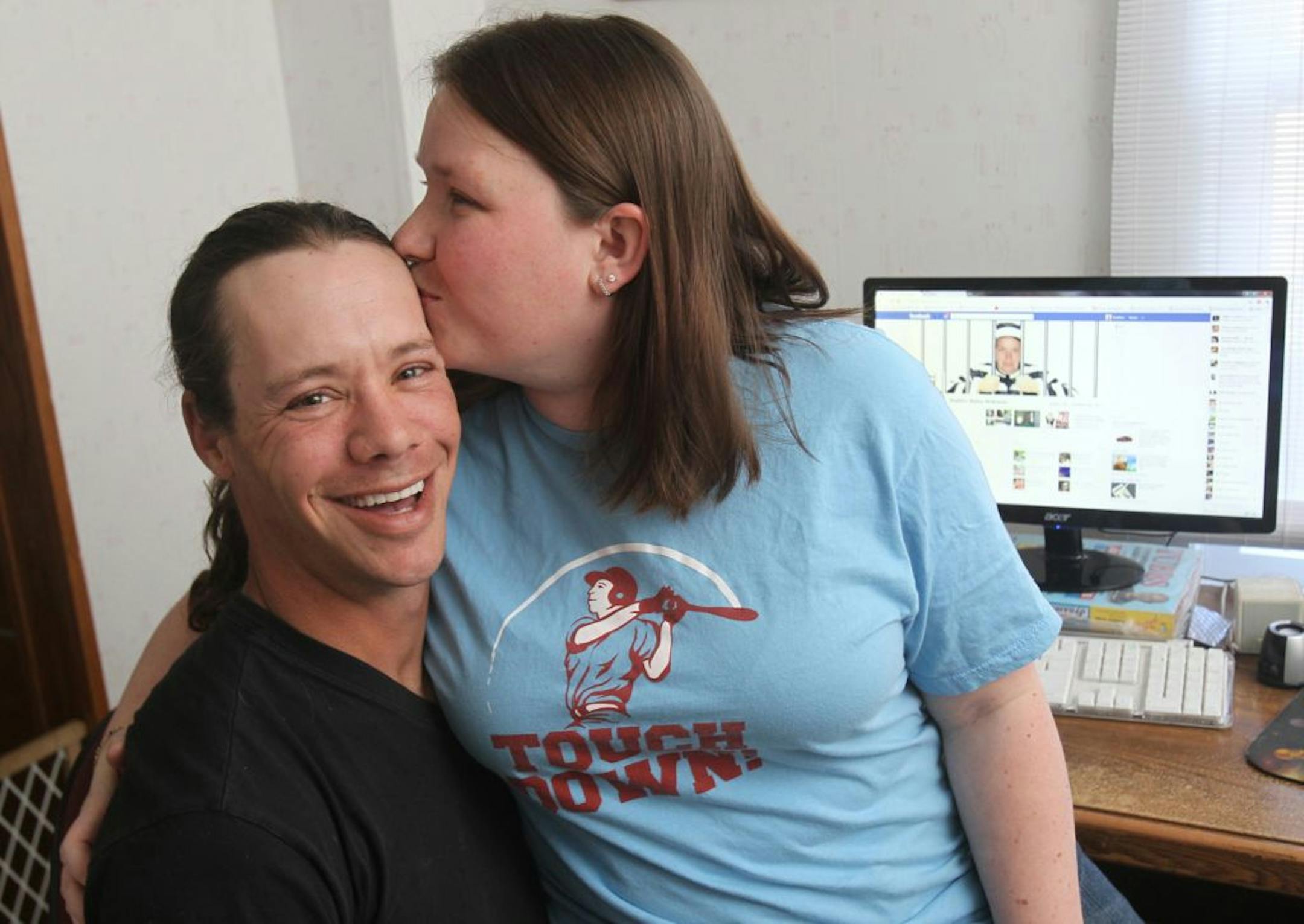Heather McKenna gave her husband, Jon, a kiss as they sat in front of Heather's Facebook page in their home in Randolph, Ohio.
