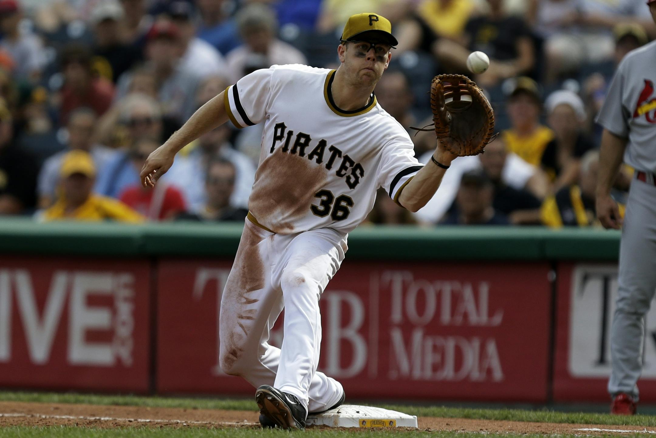 Pittsburgh Pirates first baseman Justin Morneau (36) takes a throw from Pittsburgh Pirates third baseman Pedro Alvarez to get the out at first base on St. Louis Cardinals catcher Yadier Molina (4) in the eighth inning of a baseball game in Pittsburgh Sunday, Sept. 1, 2013. The Cardinals won 7-2.