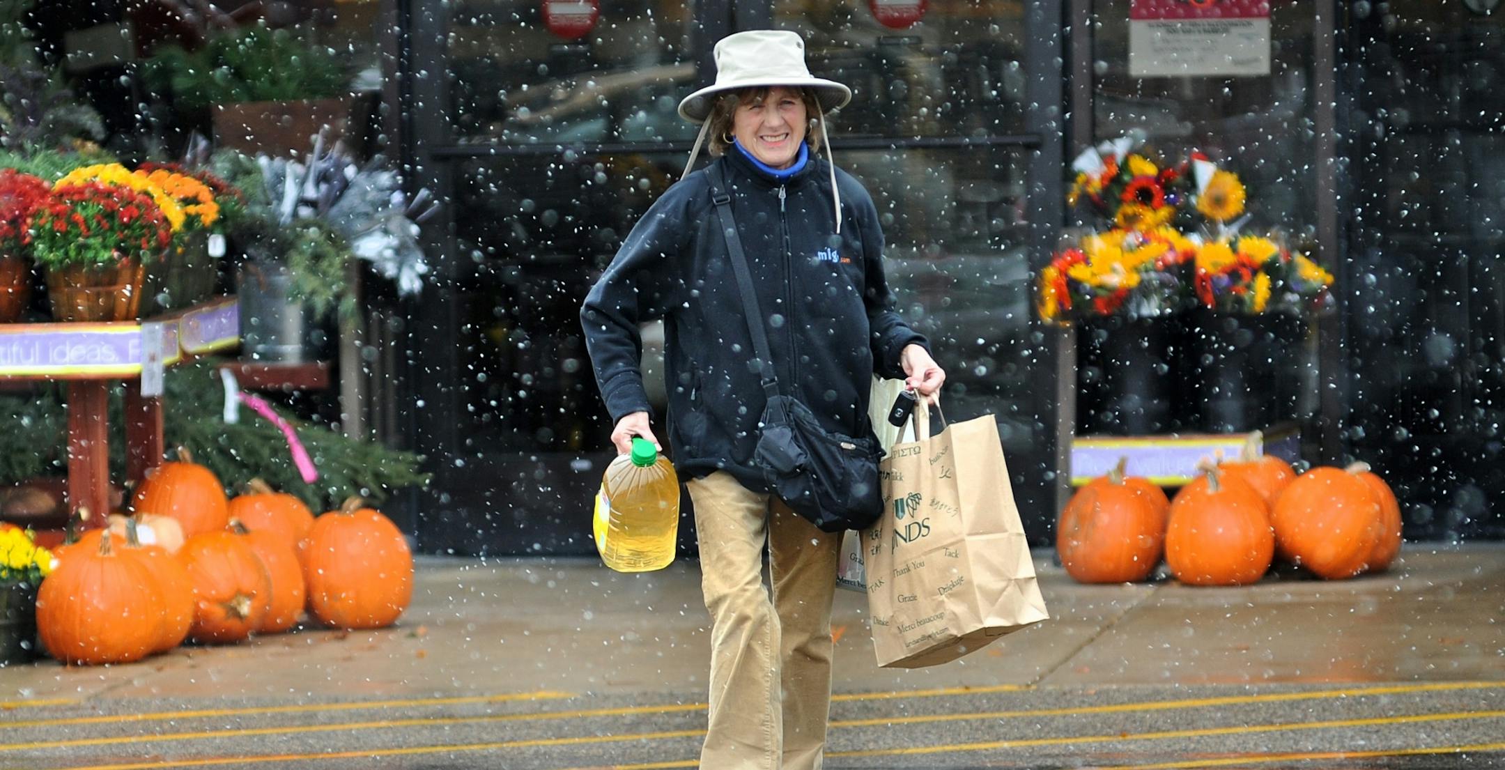 Nancy Jackson of Wayzata carried groceries through a mix of rain and snow Thursday afternoon in a Lunds parking lot in Wayzata.