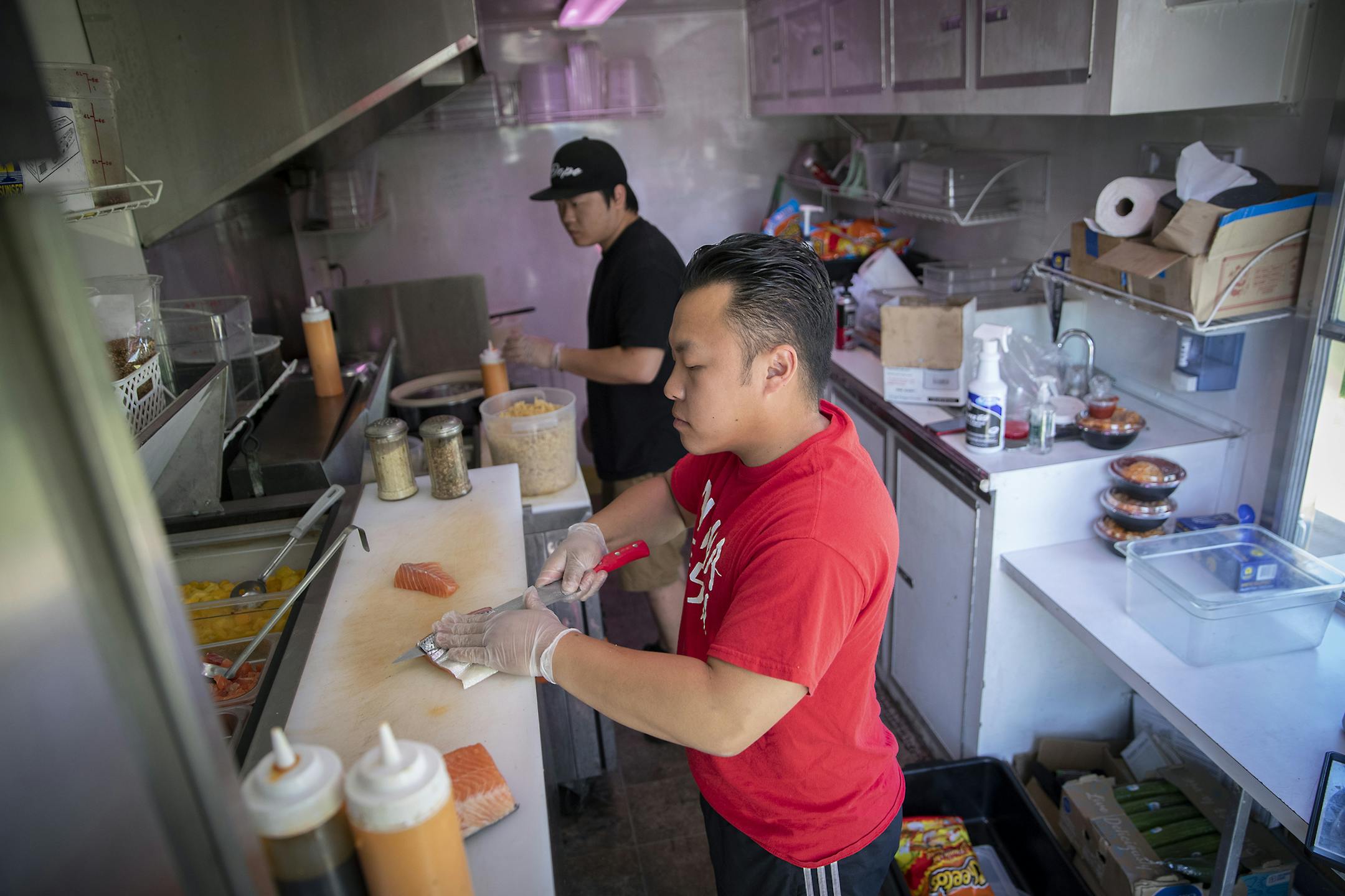 Sachoua Vang prepped the food that he would be selling later in the day from his food truck "Ninja Sushi," Friday, June 14, 2019 in St. Paul, MN. A group of food trucks that for years had enlivened a vacant lot off White Bear Avenue on St. Paul's East Side last week discovered the lot barricaded and posted with "No Trespassing" signs. It seems a permit had inadvertently been allowed to lapse. But after a handful posts to Facebook by frustrated food truck operators, city officials clearing the wa