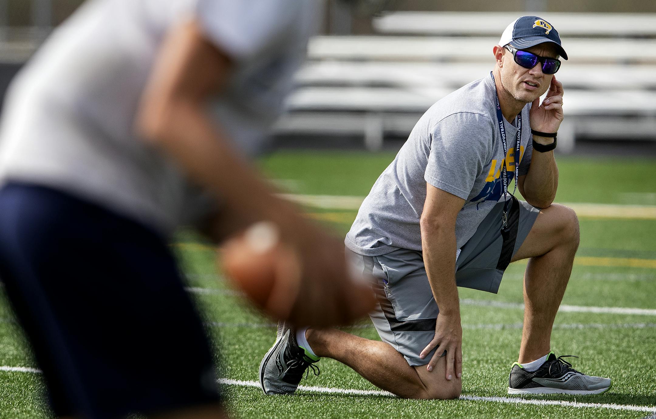 Prior Lake offensive coordinator Mark Esch, previously head coach at high-scoring Mankato West, works with quarterback Colin O'Connor at a recent practice.