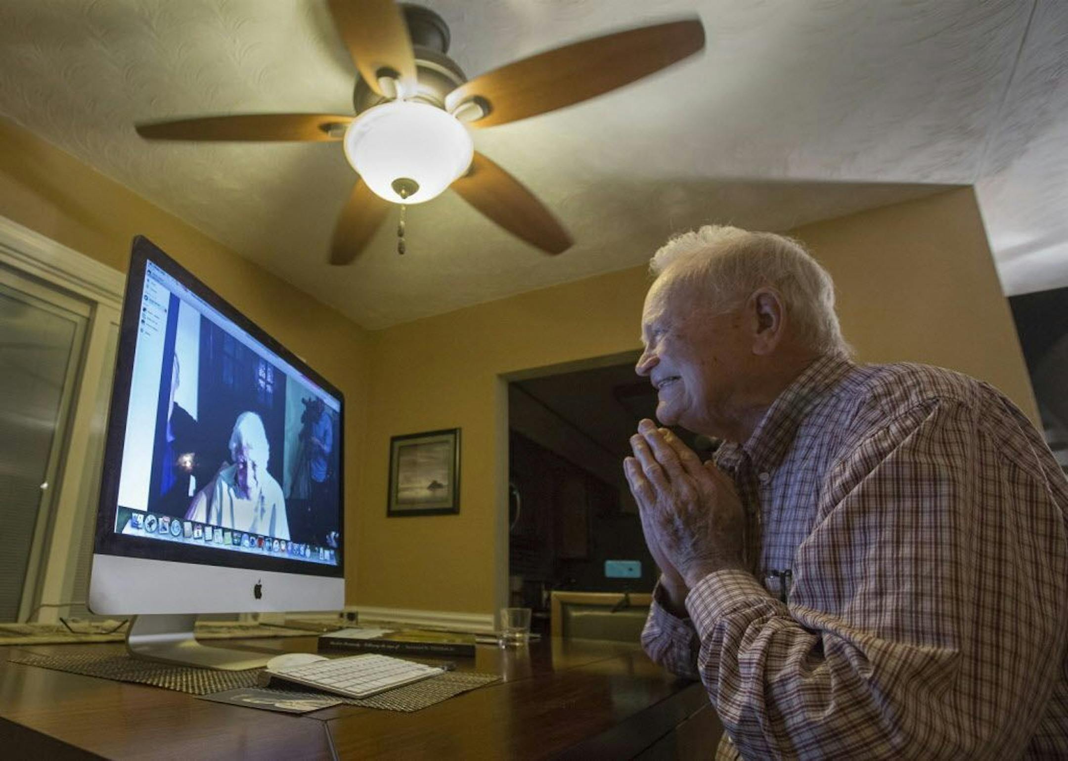 In this photo taken Nov. 6, 2015, Norwood Thomas, 93, talks with Joyce Morris via Skype from his home in Virginia Beach, Va.
