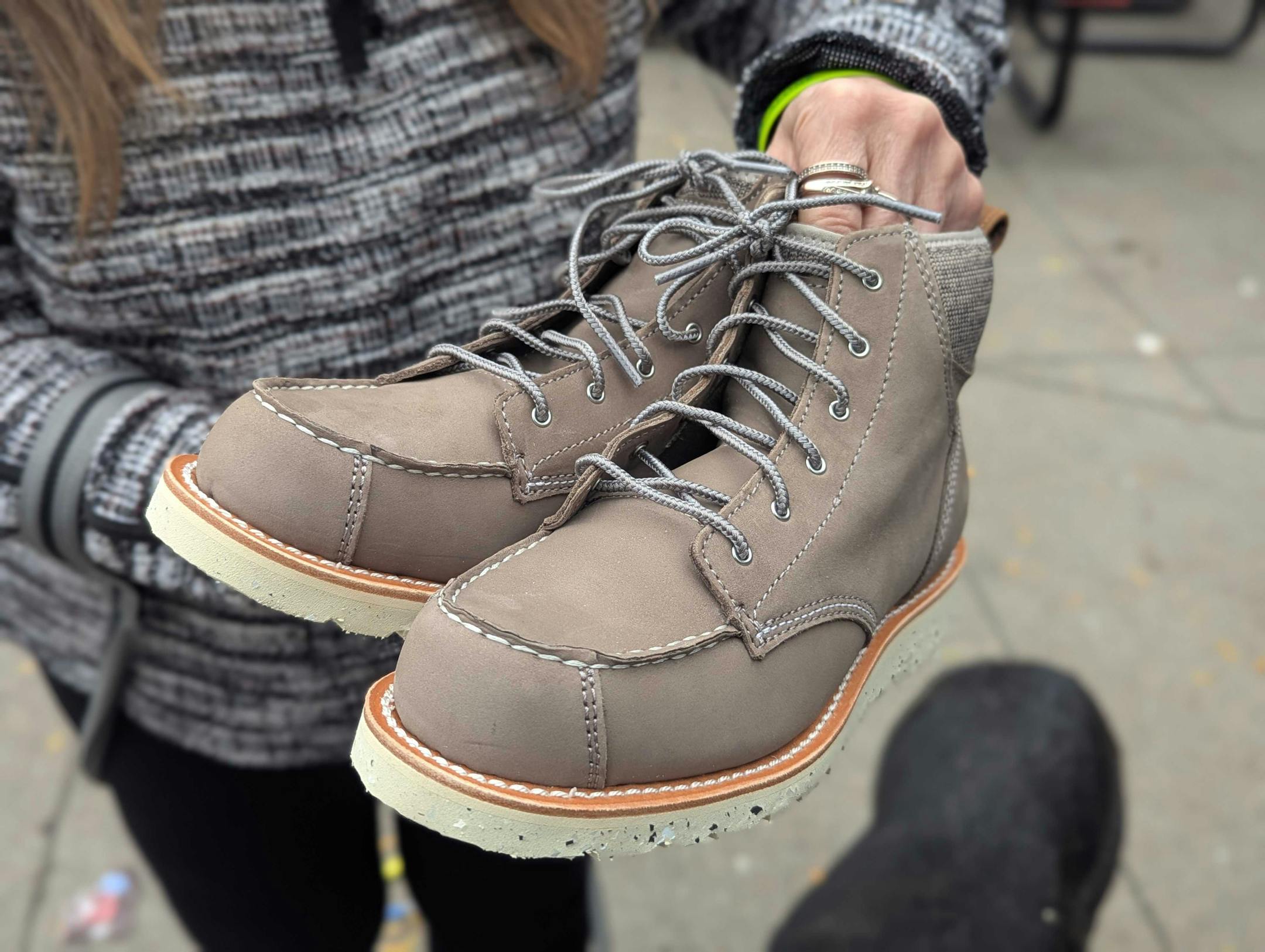 Paula Juaire, 69, holds her new shoes outside Catholic Charities "Our Hearts To Your Soles" event where volunteers donated hundreds of shoes and socks.