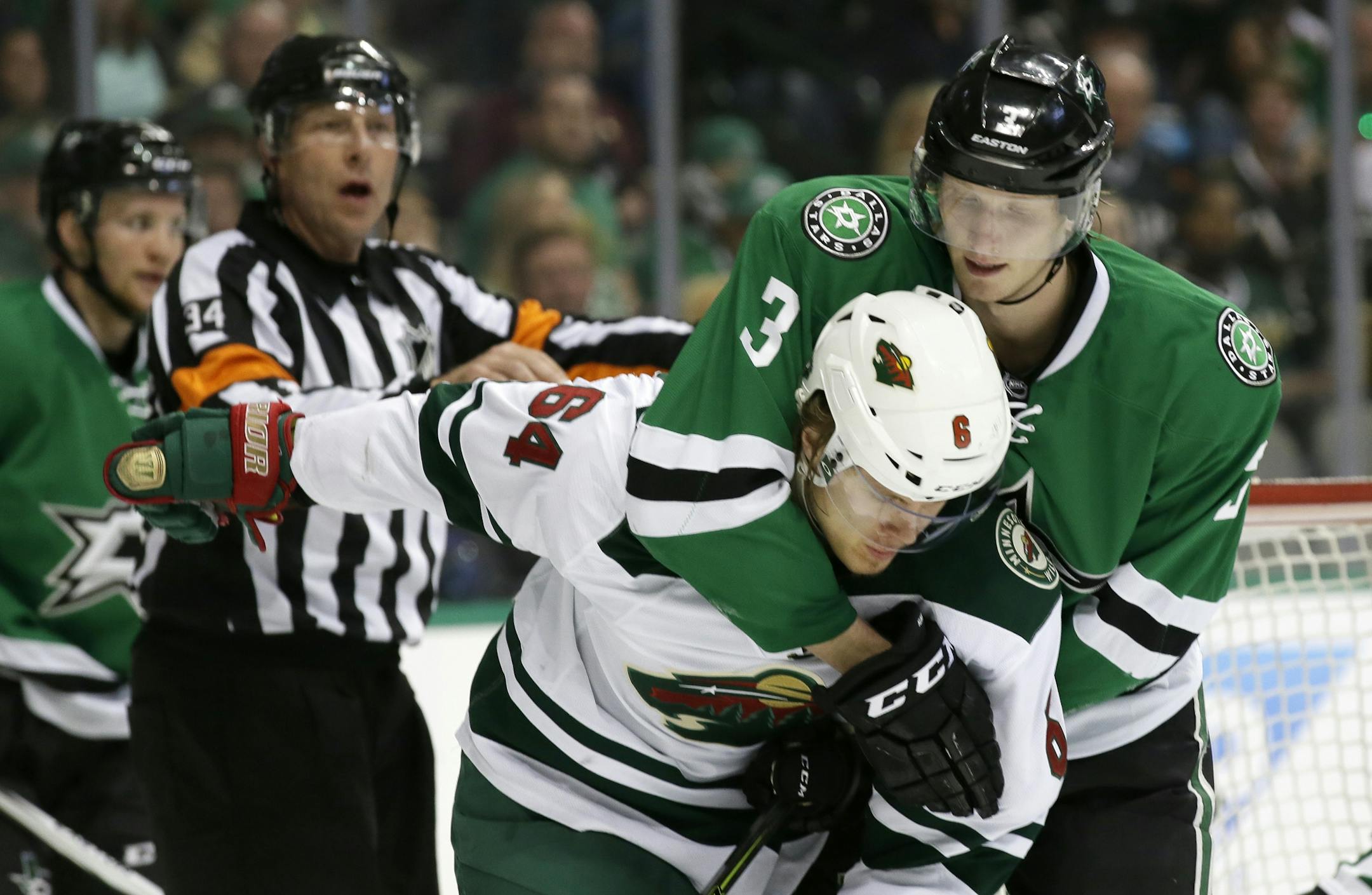Minnesota Wild center Mikael Granlund (64) and Dallas Stars defenseman John Klingberg (3) tangle during the second period in Game 2 in the first round of the NHL Stanley Cup playoffs Saturday, April 16, 2016, in Dallas.