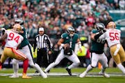 FILE — Philadelphia Eagles' Jalen Hurts looks for a receiver during the NFC Championship NFL football game between the Eagles and the San Francisco 