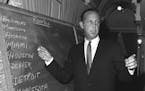 Pete Rozelle, professional football commissioner, works at blackboard at hotel in New York City on March 14, 1967 as he conducts the combined National