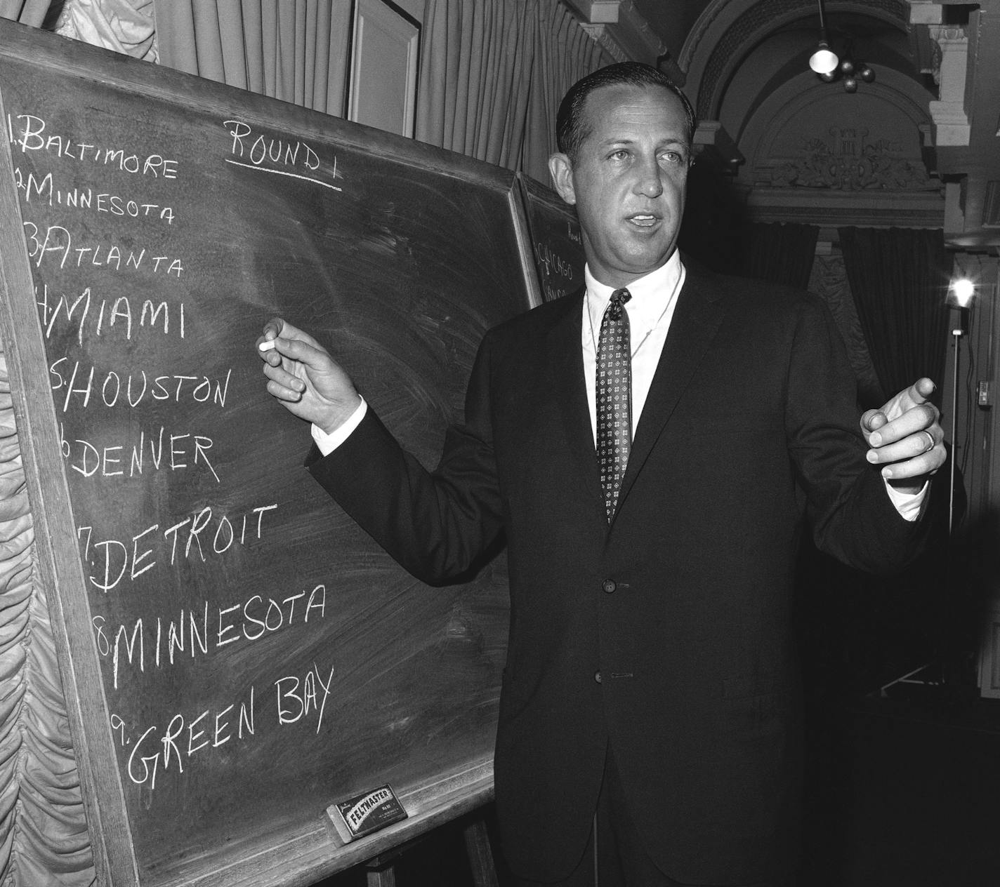 Pete Rozelle, professional football commissioner, works at blackboard at hotel in New York City on March 14, 1967 as he conducts the combined National Football League (NFL) - American Football league (AFL) football player draft. (AP Photo/Jacob Harris) ORG XMIT: APHS281765