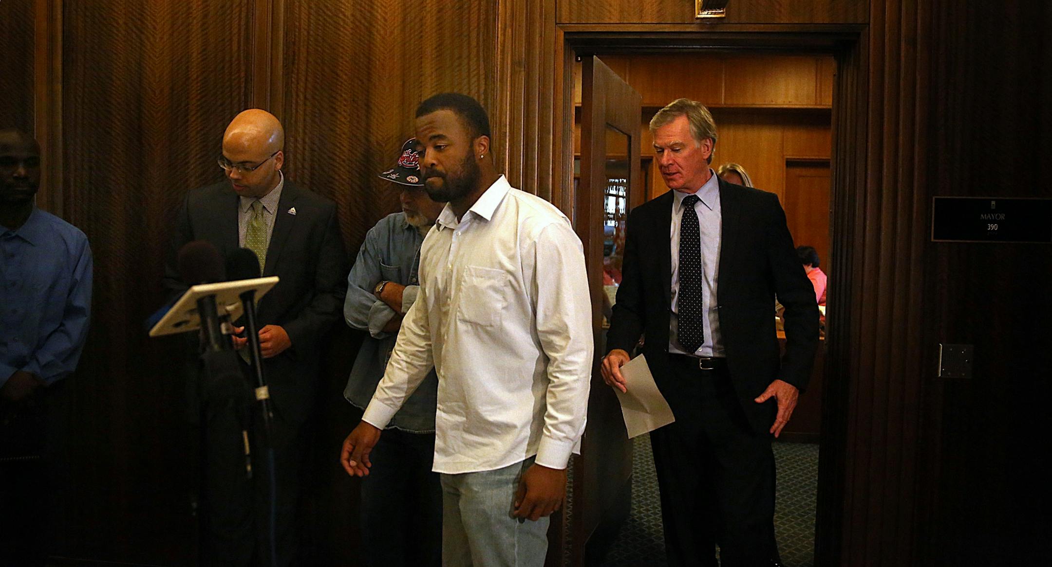 Rashad Turner, the leader of the St. Paul Black Lives Matter group (fourth from left), and St. Paul Mayor Chris Coleman emerged from Coleman�s office after meeting Thursday morning.