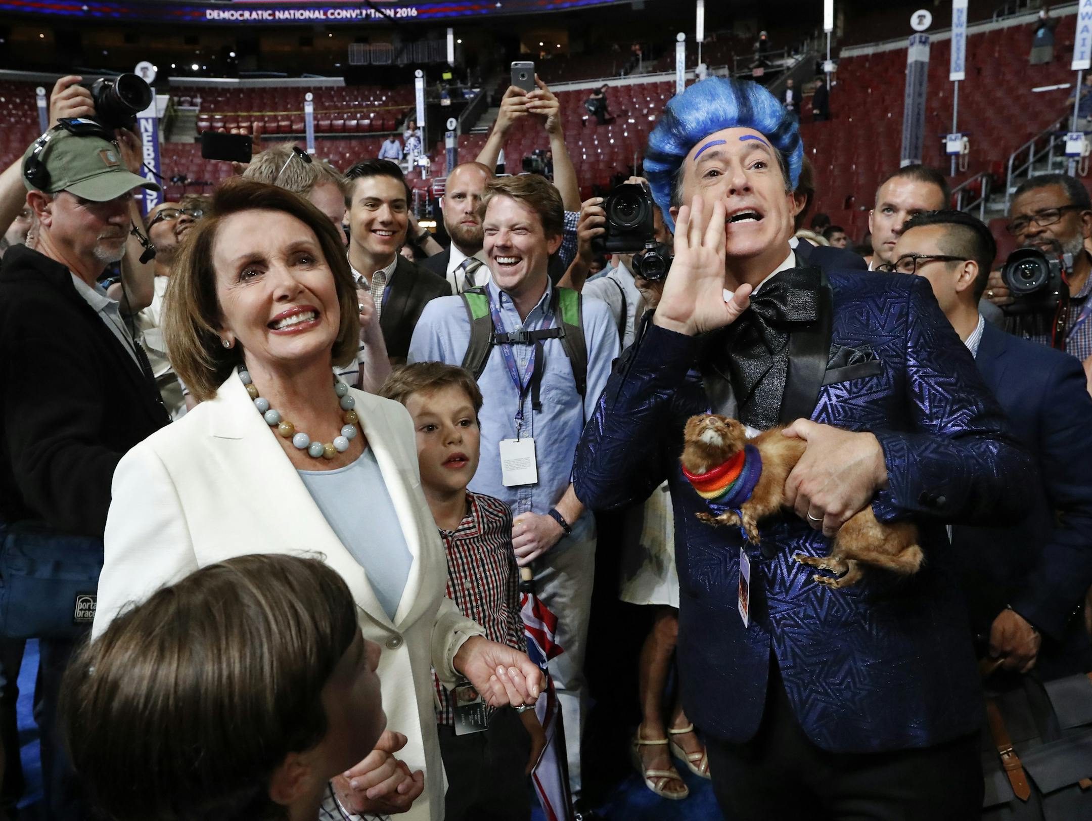 House Minority Leader Nancy Pelosi, D-Calif., left, listens while comedian Stephen Colbert records a program as preparations are underway ahead of the Democratic National Convention in Philadelphia, Sunday, July 24, 2016. (AP Photo/Paul Sancya)