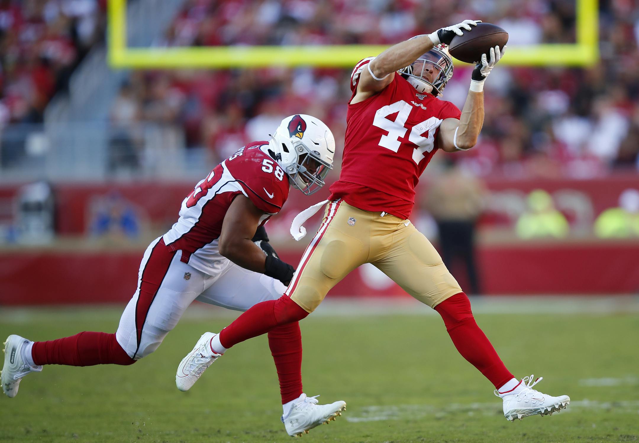 San Francisco 49ers fullback Kyle Juszczyk (44) catches a pass in front of Arizona Cardinals middle linebacker Jordan Hicks (58) during the first half of an NFL football game in Santa Clara, Calif., Sunday, Nov. 17, 2019. (AP Photo/John Hefti) ORG XMIT: FXN114