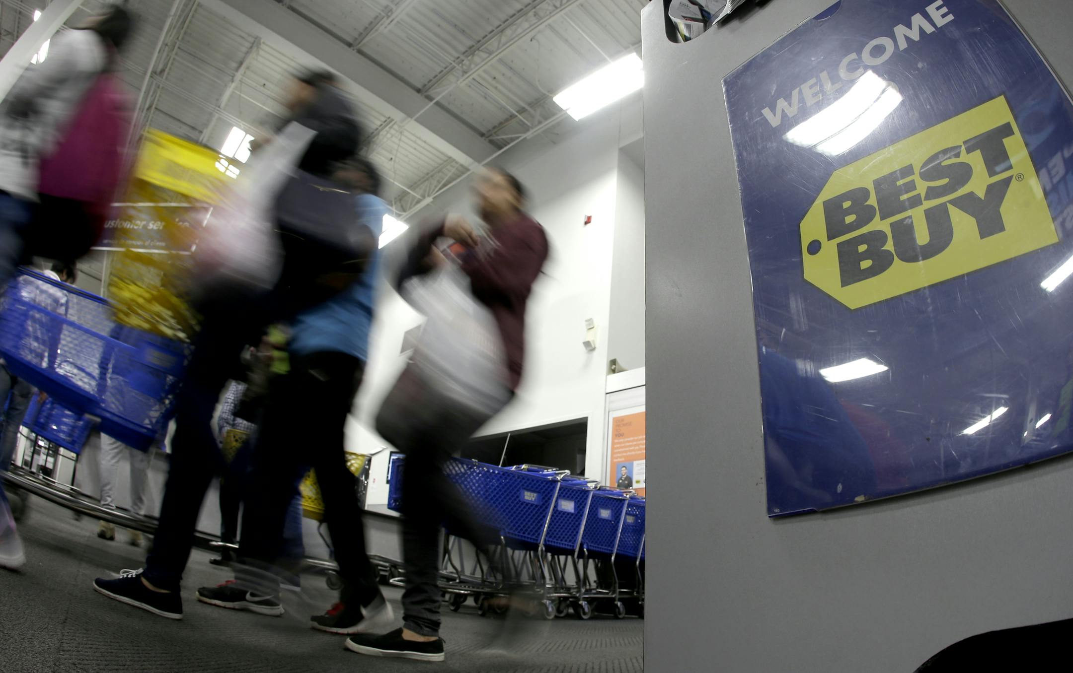 FILE- In this Nov. 23, 2017, file photo people enter a Best Buy store as it opened for a Black Friday sale on Thanksgiving Day in Overland Park, Kan. Best Buy reports financial results on Tuesday, Aug. 28, 2018. (AP Photo/Charlie Riedel, File)