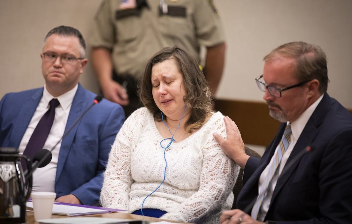 Nataliia Karia, center, with her lawyers Brock Hunter, right, and Ryan Else, reacts during her sentencing hearing.