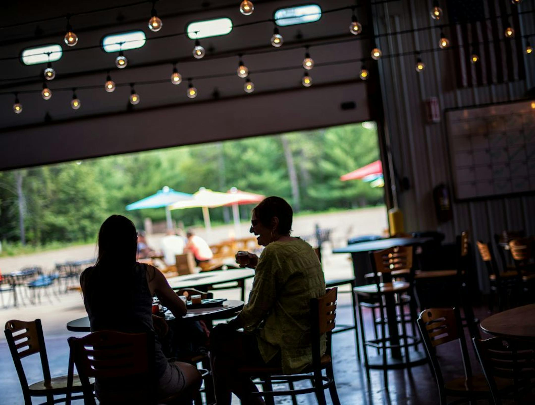 Shirley Zablocki, right and her daughter Juliana Lueneburg, left, ordered a flight of beers at Gull Dam Brewing tap room in Nisswa, MN which was still open for business despite the storm that rolled through the area.