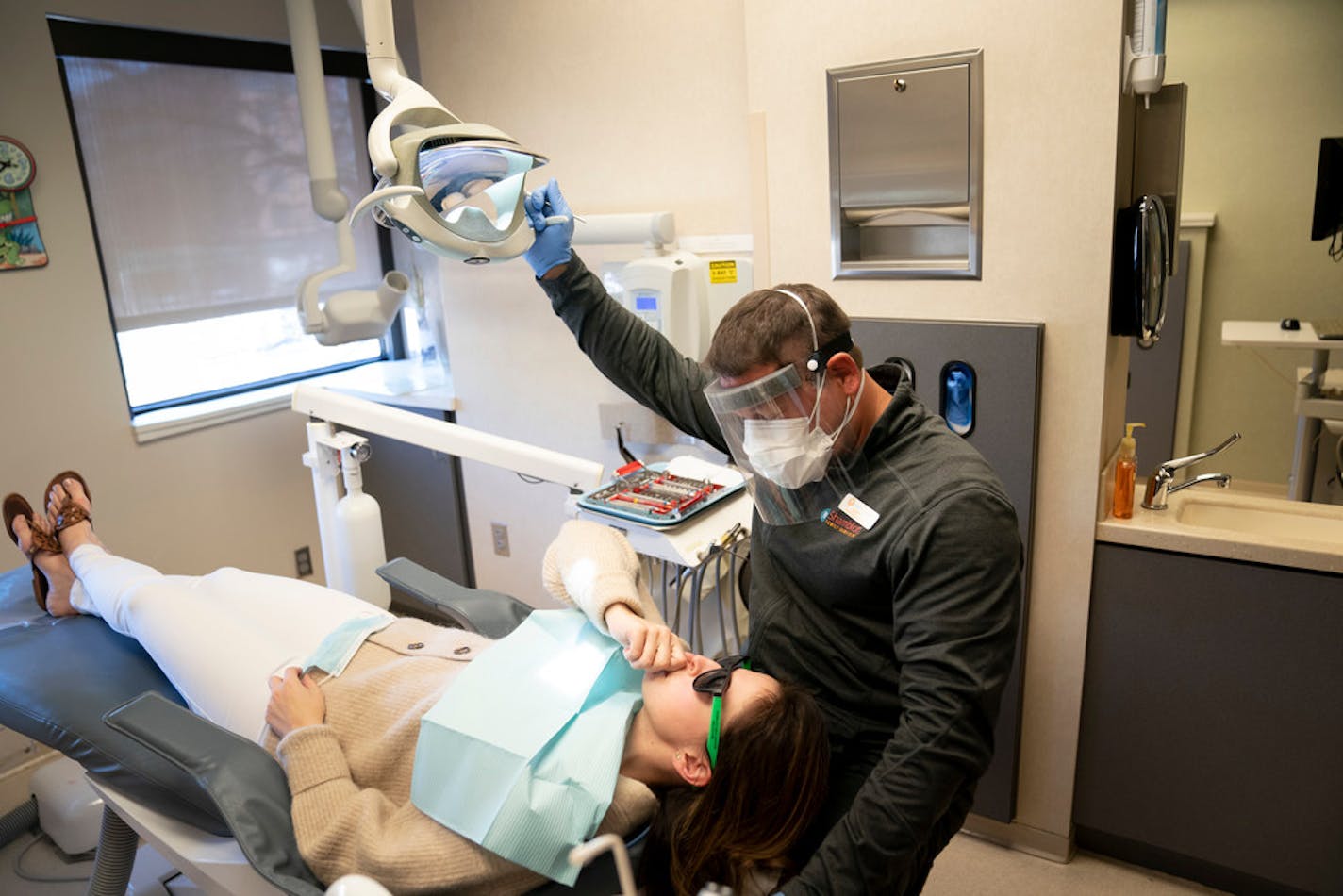 Hygienist Justin Jewison chatted with Stacy Ericson before cleaning her teeth at Shamblott Family Dentistry in Hopkins.