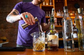 Noble Pour general manager Tyler Schwanke made one of the Duluth lounge's signature cocktails, Midnight Song, behind the bar in December 2019.