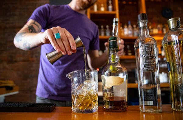 Noble Pour general manager Tyler Schwanke made one of the Duluth lounge's signature cocktails, Midnight Song, behind the bar in December 2019.