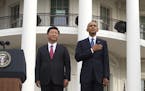 President Barack Obama and Chinese President Xi Jinping during a 21-gun salute welcome ceremony in Xi's honor on the South Lawn of the White House, in