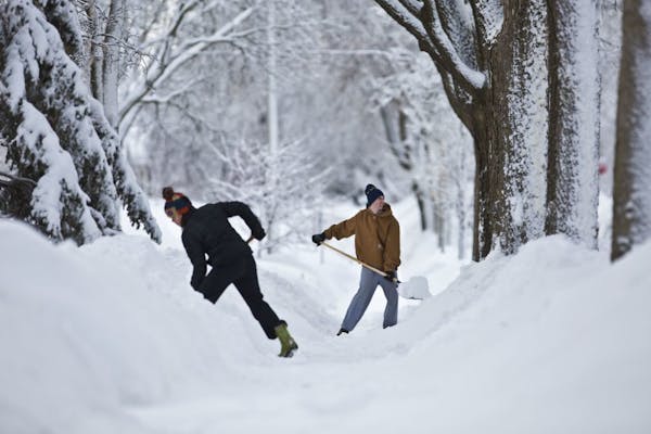 Neighbors Andrea Page and Peter Jorgensen were two of several neighbors clearing the sidewalk of their Minneapolis neighborhood which had still yet to