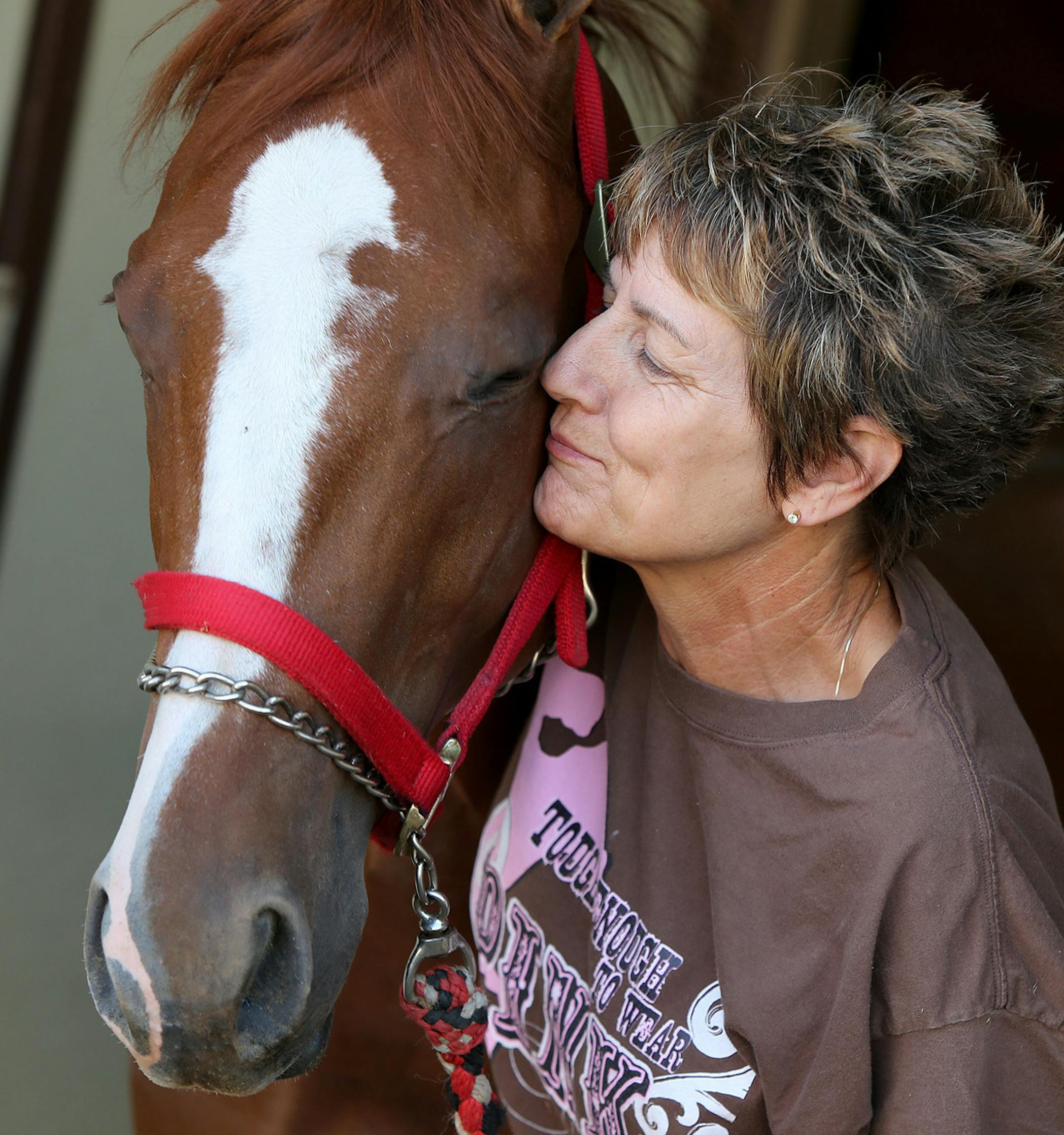 Stacy Charette-Hill gave her horse High Ace a kiss at Canterbury Park as she got it ready for a race on Friday.