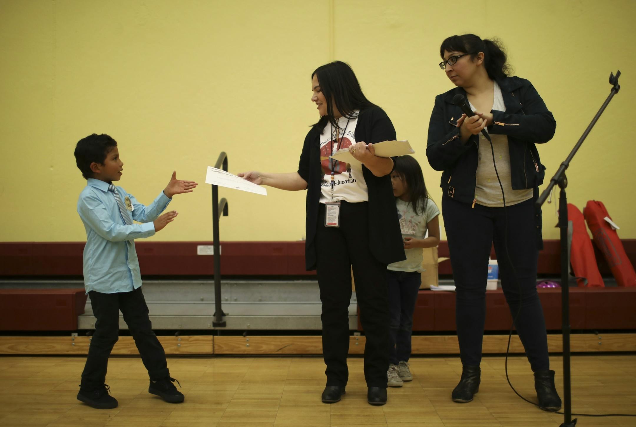 Levi Hunt-Holubar received his award for good attendance from (name to come) after it was read by emcee Marisa Carr, right.