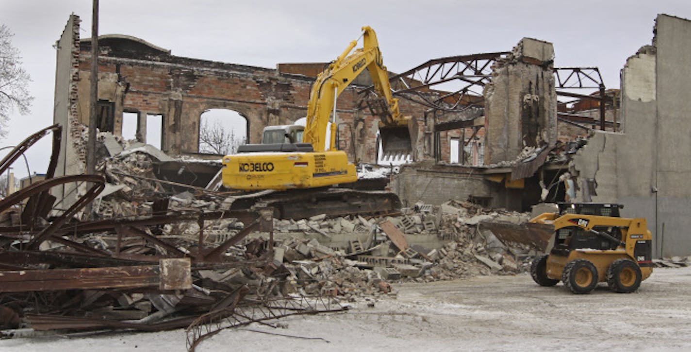 Demolition crews tear down the fire-gutted Gustavus Adolphus Hall Building at 1626 East Lake Street.