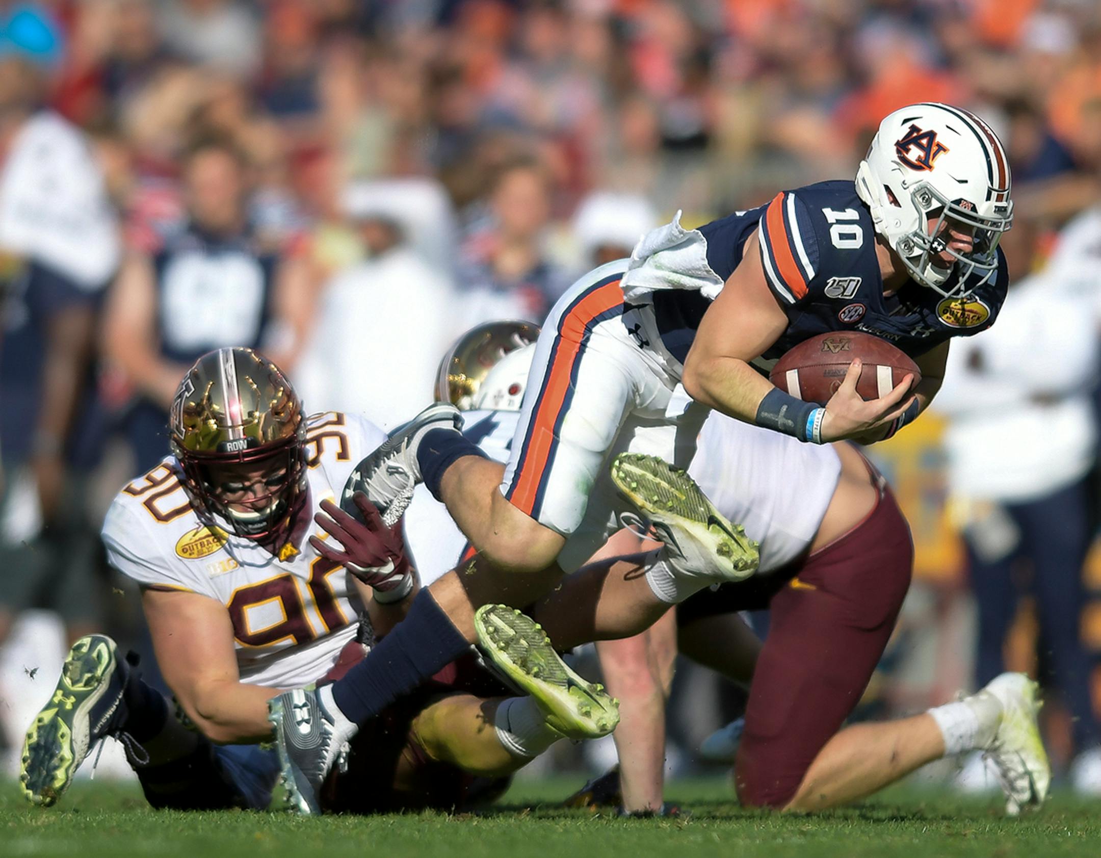 Minnesota Gophers defensive lineman Sam Renner (90) sacked Auburn Tigers quarterback Bo Nix (10) in the third quarter.