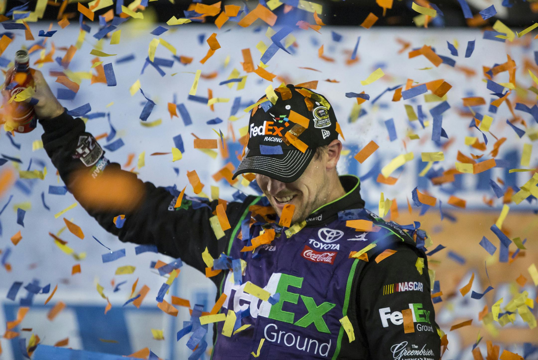 Denny Hamlin celebrates after winning the NASCAR Sprint Cup auto race at Richmond International Raceway in Richmond, Va., Saturday, Sept. 10, 2016. (AP Photo/Chet Strange)