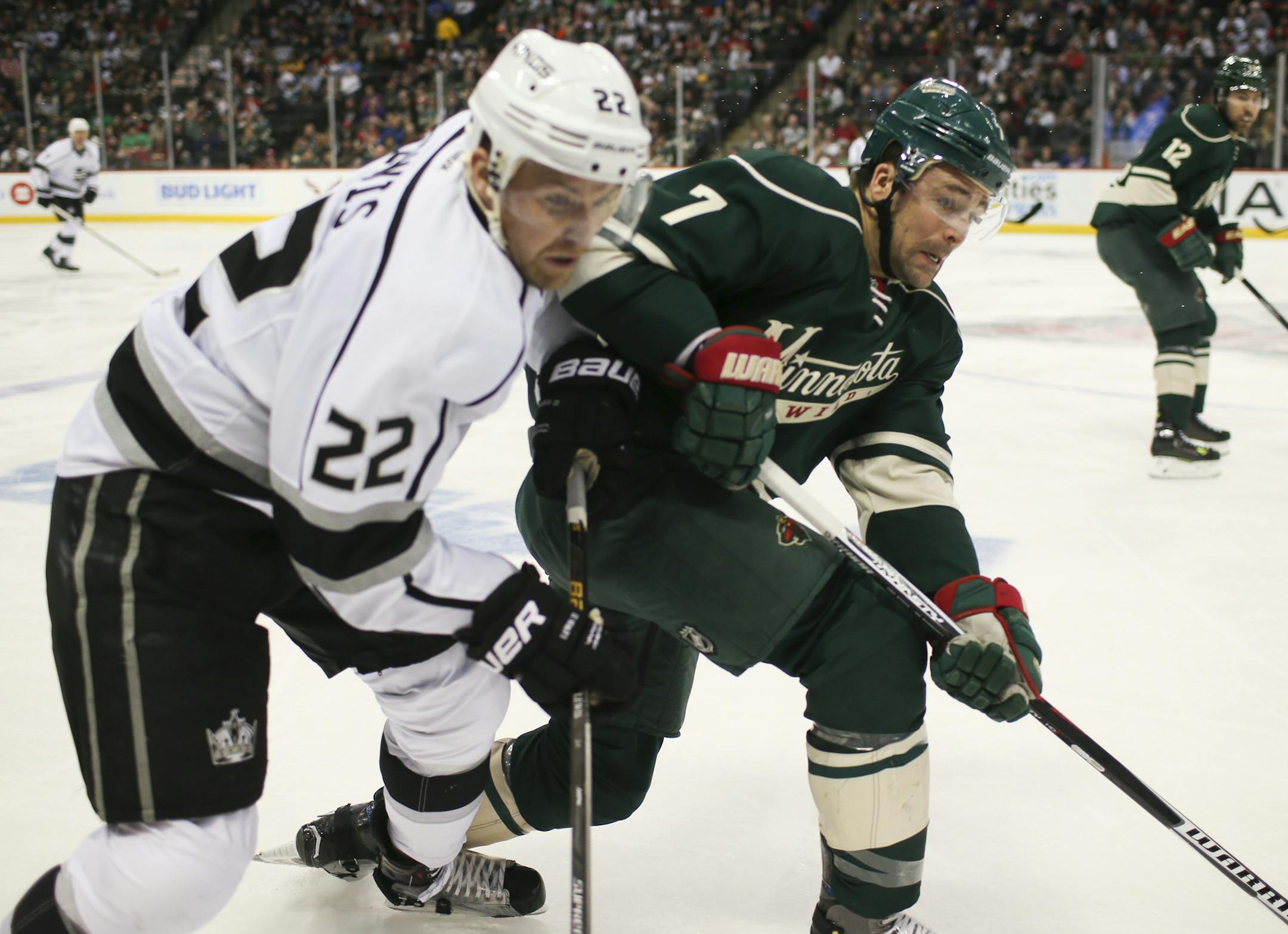 Kings center Trevor Lewis and Wild left winger Chris Porter battled for the puck near center ice in the second period.